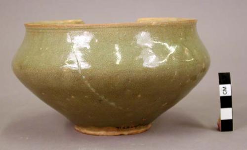 Grey ware bowl - heavy green glaze; faint pattern of conventional flowers inside, leaves outside;