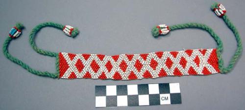 Bead bracelet - red and white, diamond design; green cord tie