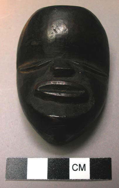 "Mã."  Small wooden mask, property of a man who prays to it for good luck and a