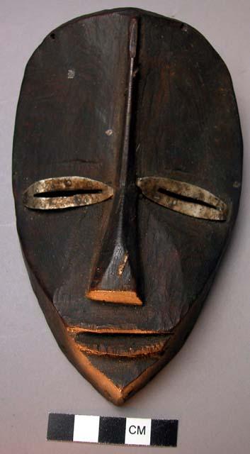 Miniature wooden face mask.