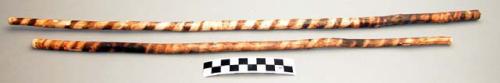 Pair of fire sticks, wood, horizontal stripe markings