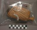 Raffia covered pottery whistle, used to create voice of the "Ge"