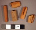 5 red pipe stem fragments (longest fragment 4.4 cm.)