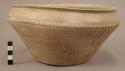 Pottery bowl - grey ware; traces of glaze; narrow hatched border near rim; wide body & rim, tapering to narrow base