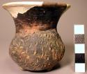 Small pottery tripod jar with high flaring neck, punctated bowl; 3 small knob fe