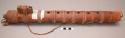 Arapaho flute. Fastened w/ strips of leather, carved wood over stop