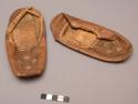 Pair of child's moccasins. Made of tan/brown leather.