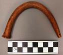 Curved object of wood, bent wood, polished smooth, one end flattened the other n