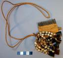 Dorsal neck pendant - black wooden comb with bead and bone pendants; ceremonial