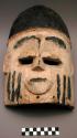Ekpo mask, wood with white and black paint, three black stripes on each cheek