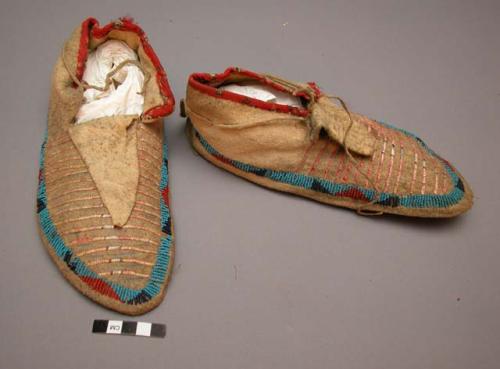 Pair of Sioux moccasins. Hard soles with soft uppers. Triangular shaped tongue.