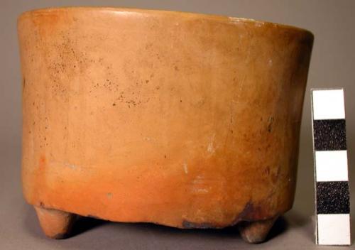 Plain tan flat-bottomed straight sided tripod pottery bowl