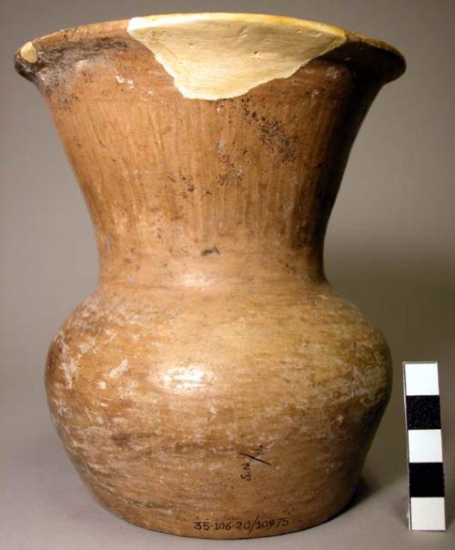 Tan pottery jar with flaring neck