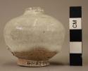 Small white glazed jar with very small neck & mouth