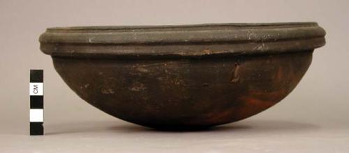 Ceramic complete bowl, mended, with comb-marked loop designs inside