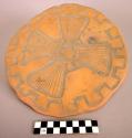 Ceramic dish, disk shaped, uneven rim, incised geometric designs