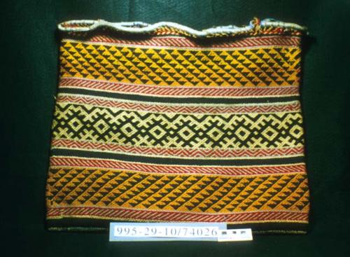 Weft-twined bag in orange, navy blue, red, blue faded to grey, and yellow