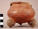 Small tripod pottery vessel with incised designs