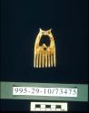 Small owl-shaped comb of ivory with red bead eyes