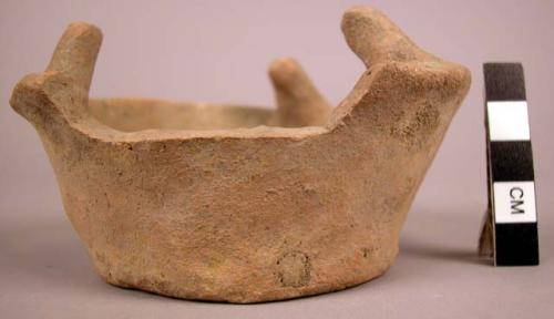 Clay oven(?)-plain ware bowl-like object; stands with base up on three legs jutt