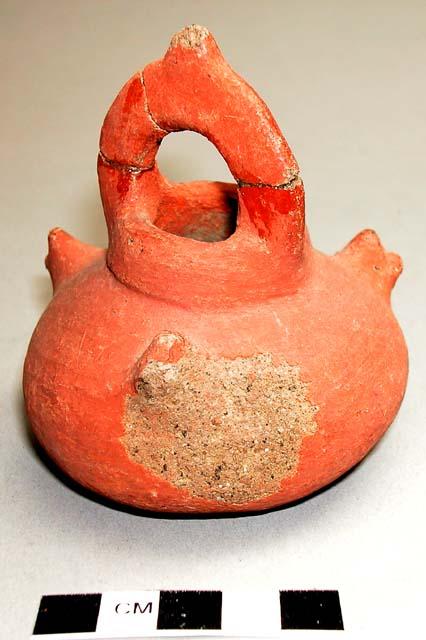 Small red pottery vessel - handle broken