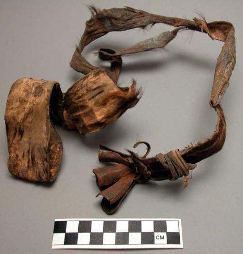 Necklace of strip of cowhide with iron bells