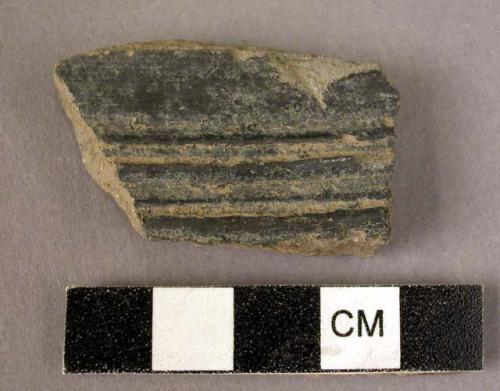 Potsherd - shiny black outside; dull black inside