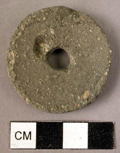 Large circular stone spindle whorl