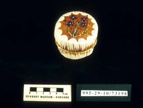 Miniature quilled birch bark basket (A) with lid (B); flower motif