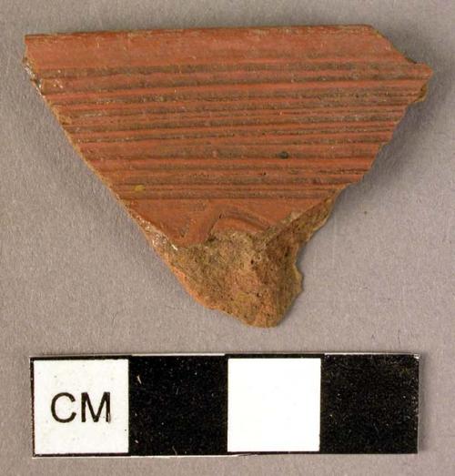 Ceramic rim sherd, red, incised band of horiz lines, wavy line below