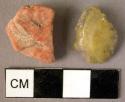 Stone, ground stone implements, fragments, olive, orange, polished