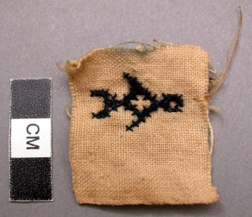 Piece of textile with human figure embroidery