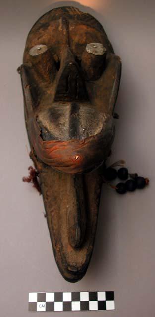 Long wooden mask.